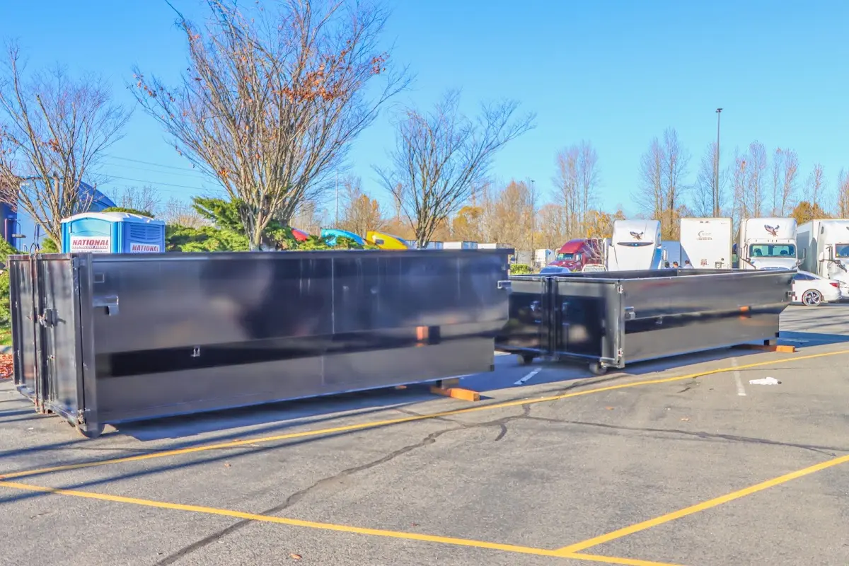 Professional dumpster rental service with roll-off container on residential driveway in La Grande